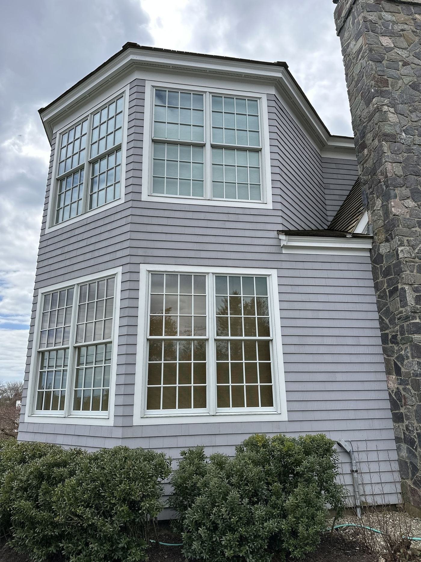 Bay window exterior trim and siding painting in Massachusetts