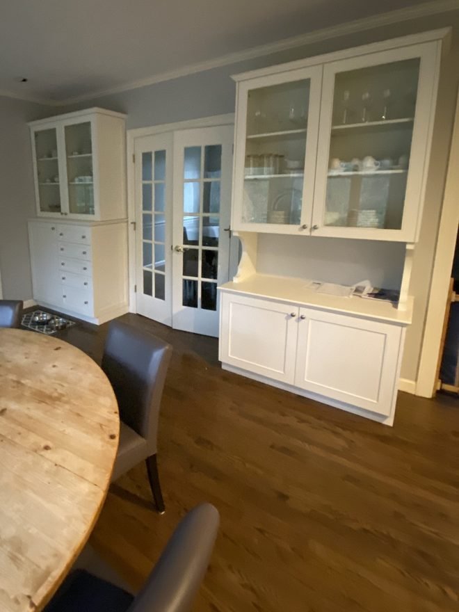 White built-in china cabinet with glass doors freshly painted