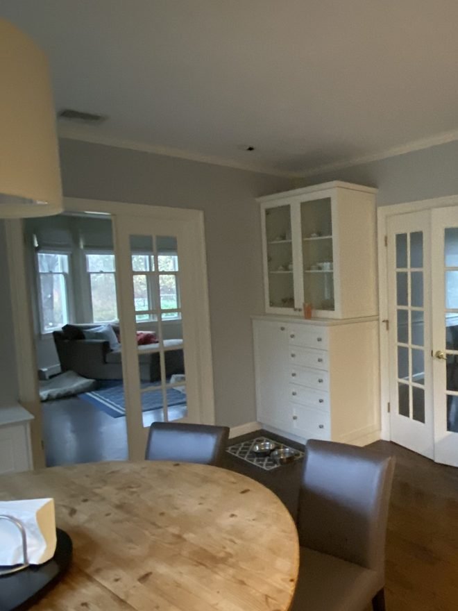 Dining room built-in cabinetry and French doors finished in white